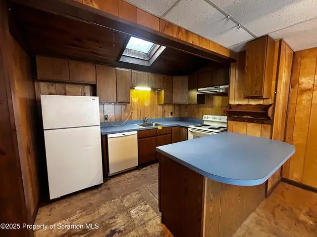 a kitchen with refrigerator and cabinets