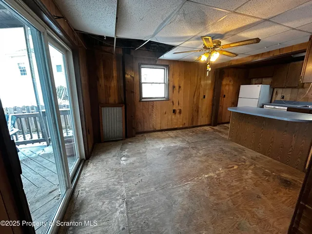 a view of a hallway with furniture