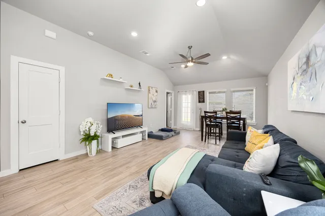 a living room with furniture and a flat screen tv