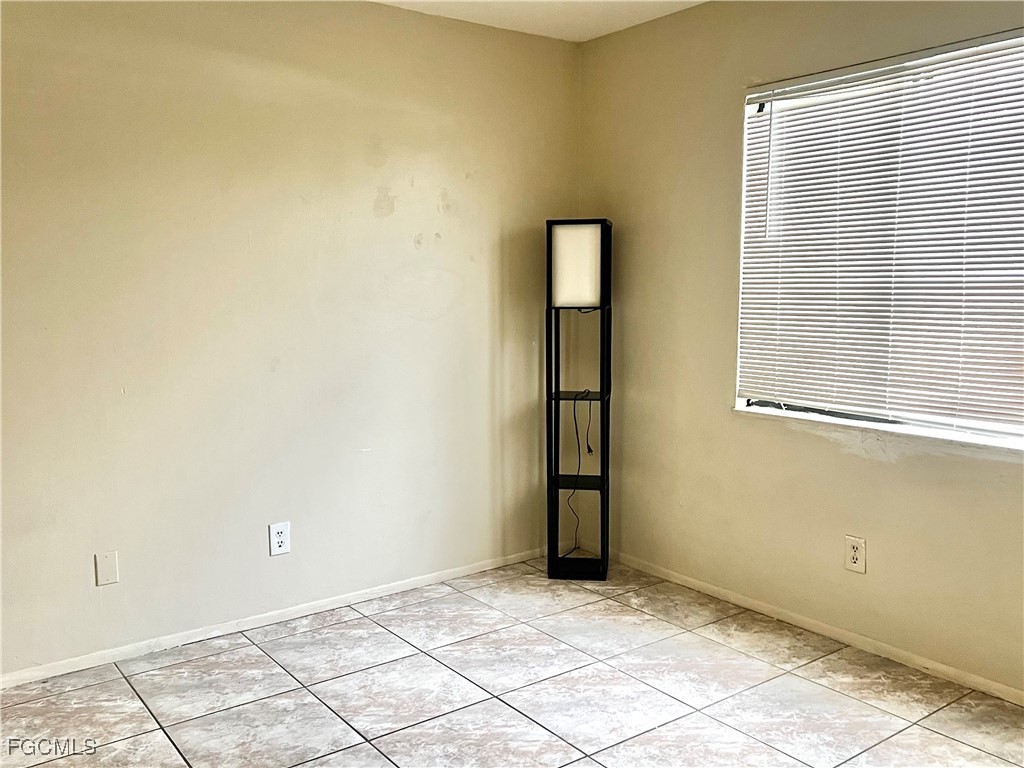 824 Alderman Street, Unit 106 Fort Myers, FL 33916 - Photo 4 of 6 a view of an empty room with window and wooden floor