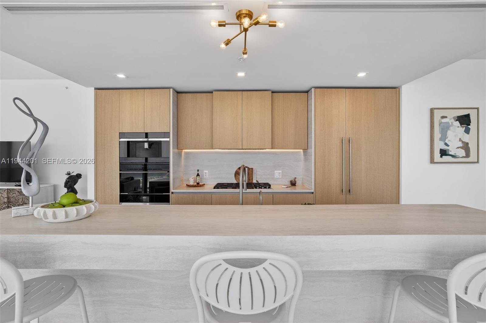 900 North Ocean Boulevard, Unit 906 Pompano Beach, FL 33062 - Photo 13 of 100 Chef-ready galley kitchen with Sub-Zero and Wolf appliances w/ wine cooler, plus integrated espresso/cappuccino system. Italian cabinetry and stone counters