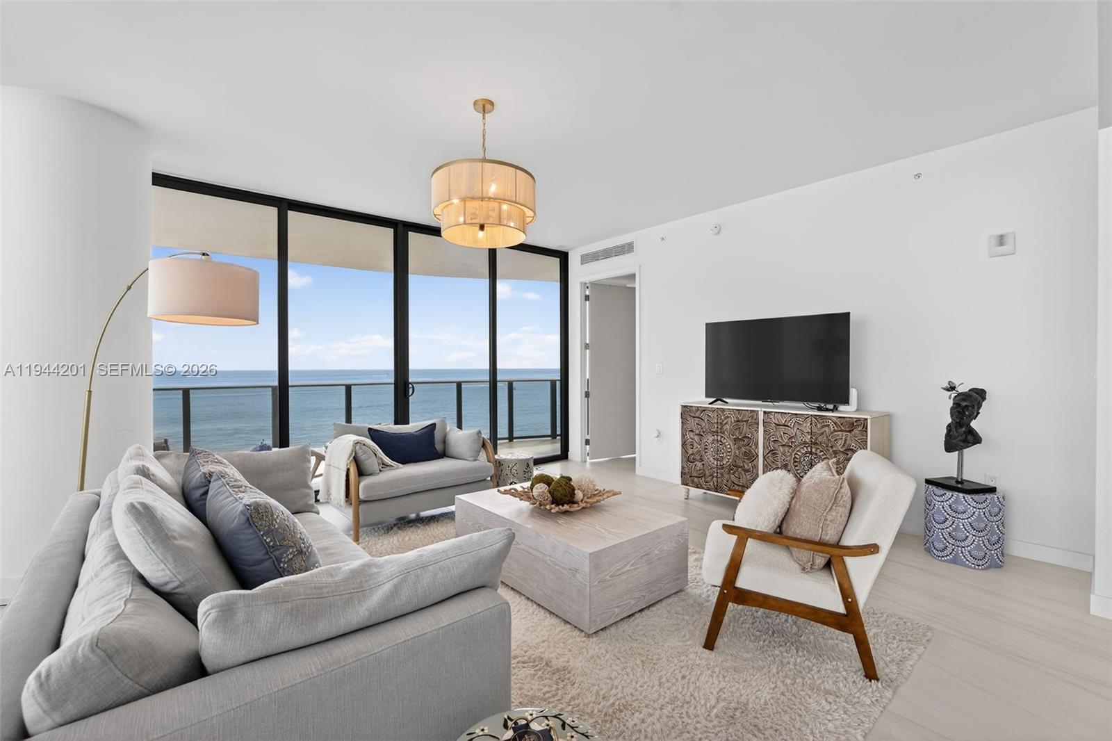 900 North Ocean Boulevard, Unit 906 Pompano Beach, FL 33062 - Photo 20 of 100 Light filled open living area with floor to ceiling glass and seamless indoor outdoor flow to expansive terrace.