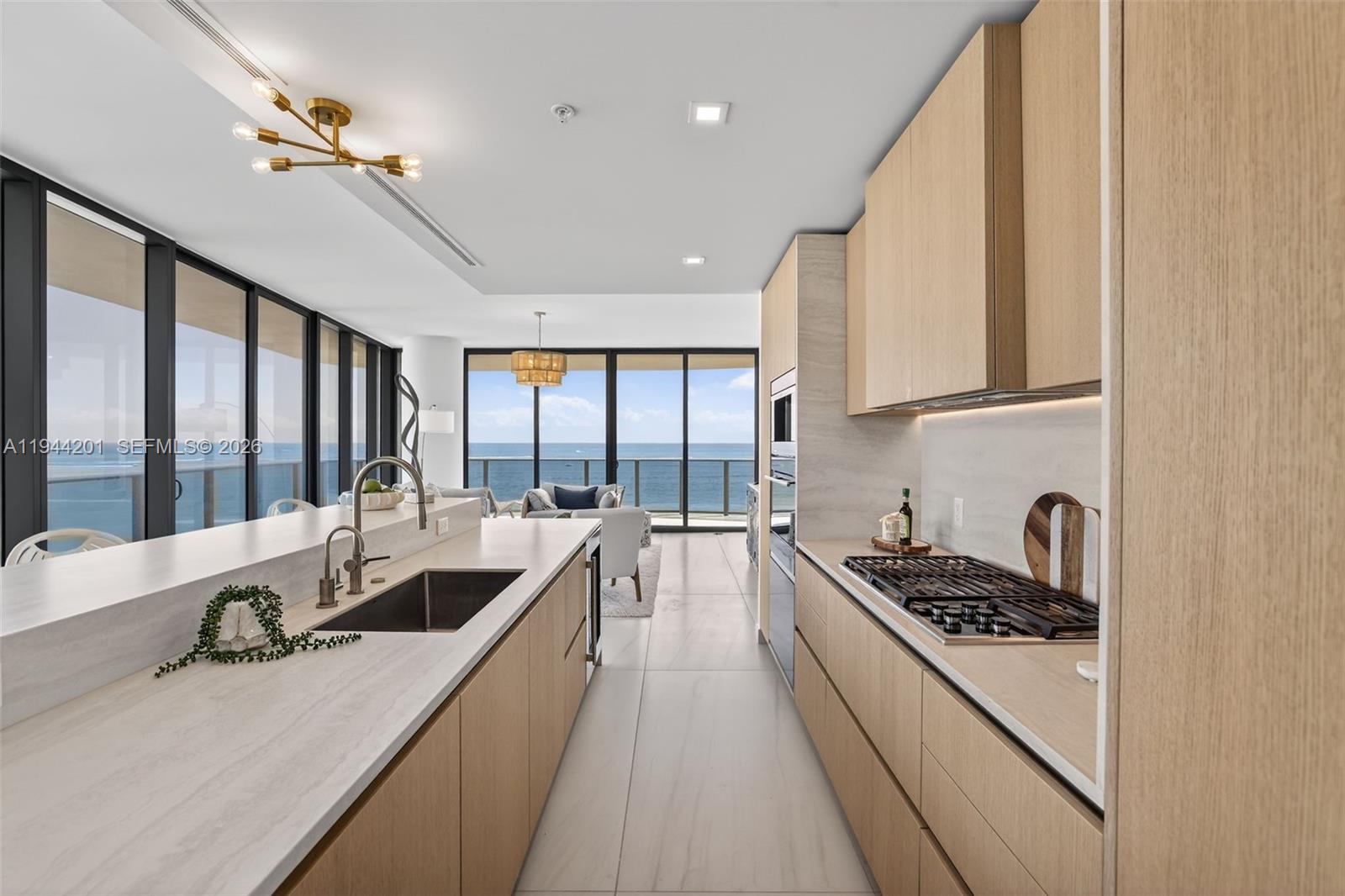 900 North Ocean Boulevard, Unit 906 Pompano Beach, FL 33062 - Photo 2 of 100 Chef-ready galley kitchen with Sub-Zero and Wolf appliances w/ wine cooler, plus integrated espresso/cappuccino system. Italian cabinetry and stone counters. Gas Cooktop