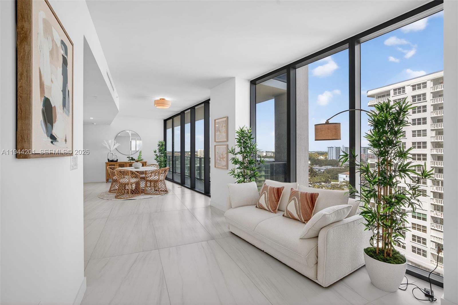 900 North Ocean Boulevard, Unit 906 Pompano Beach, FL 33062 - Photo 24 of 100 Light filled open living area with floor to ceiling glass and seamless indoor outdoor flow to expansive terrace.