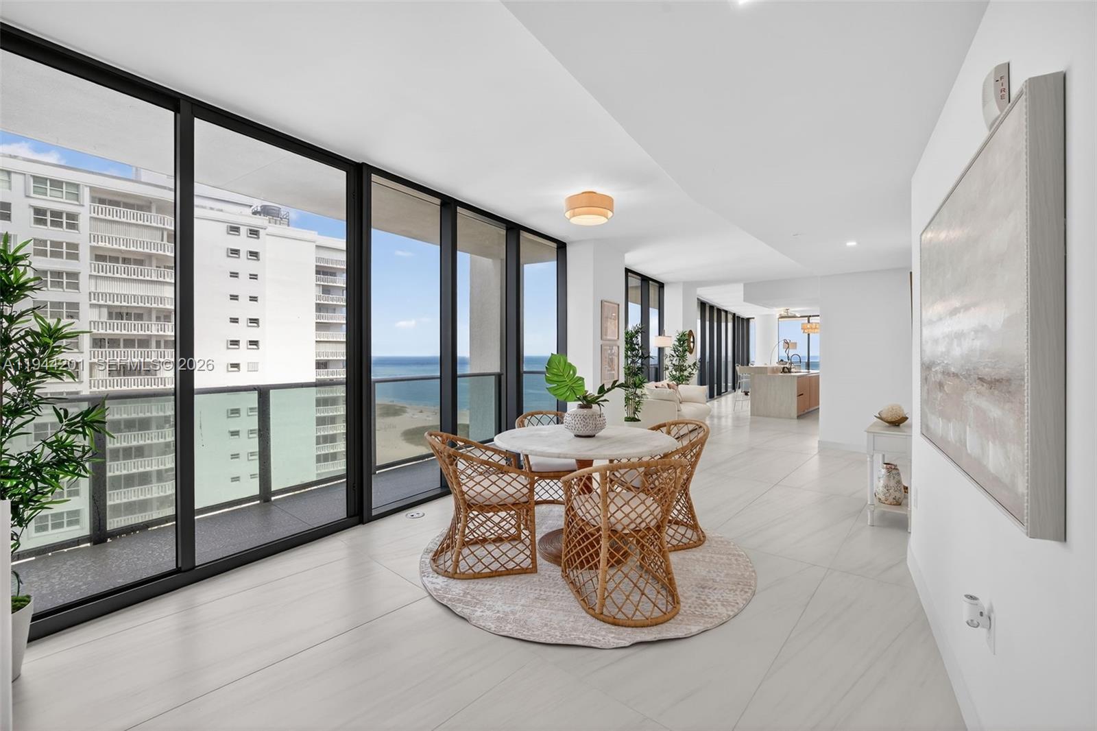 900 North Ocean Boulevard, Unit 906 Pompano Beach, FL 33062 - Photo 29 of 100 Open dining area with floor to ceiling glass, adjacent to chef’s kitchen and terrace for seamless indoor outdoor entertaining. This area is also a possible den / 4th bedroom as per the builders plans. Unit is a 4 bedroom per tax roll