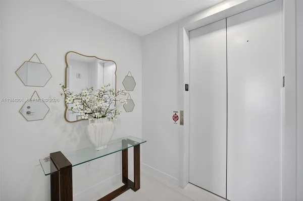 a large kitchen with kitchen island a large window a sink and stainless steel appliances