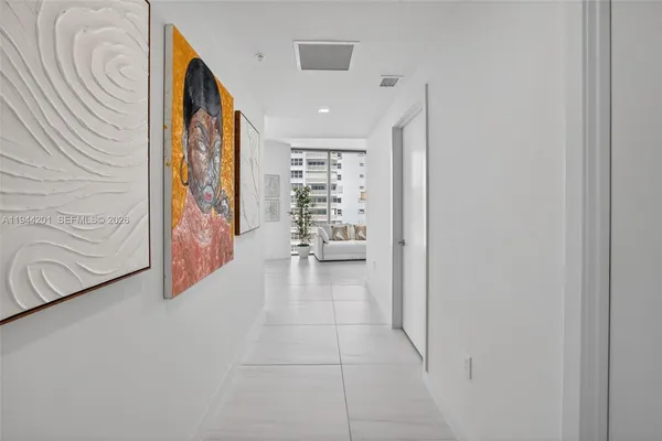 a living room with furniture a flat screen tv and a large window