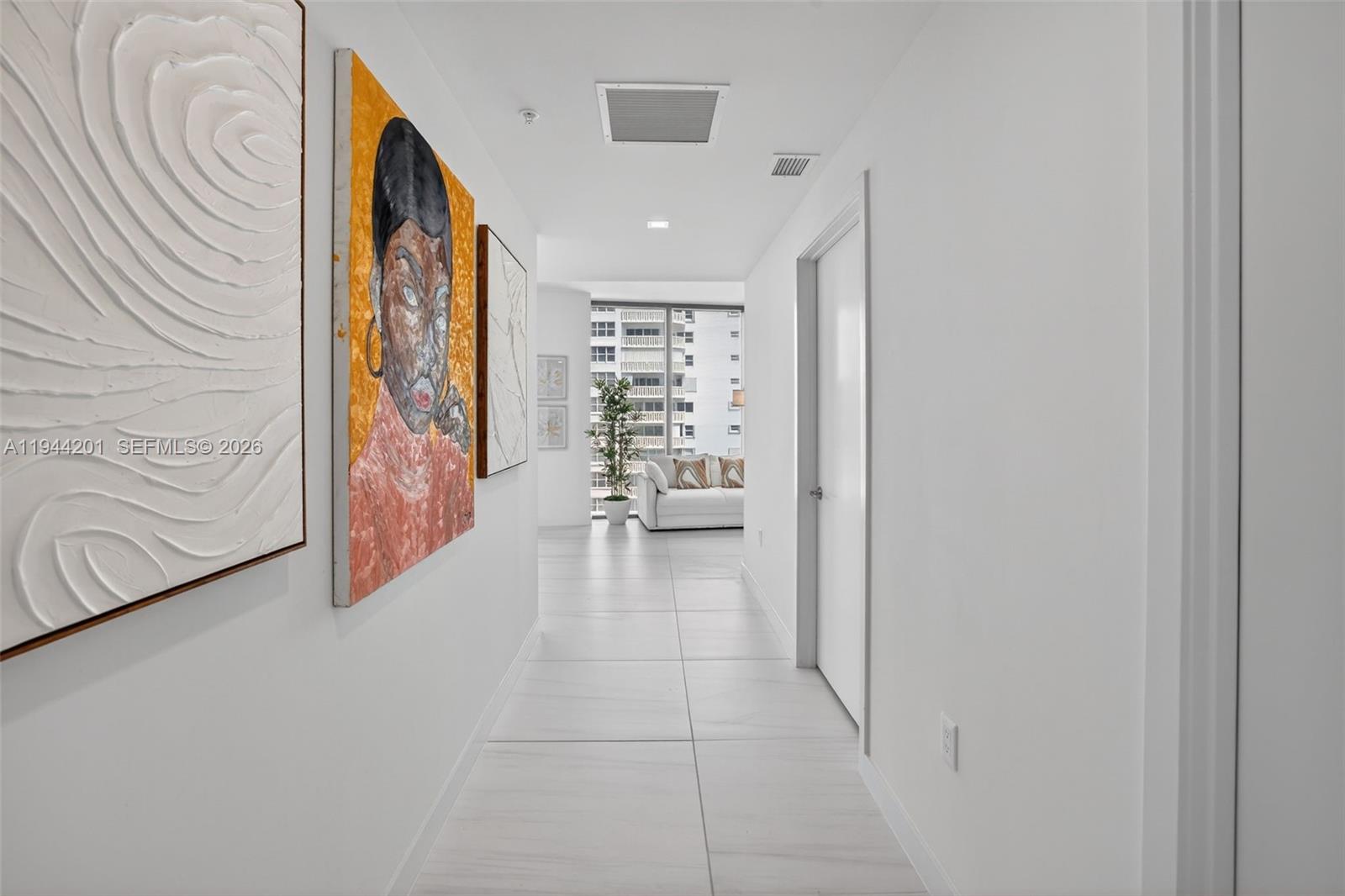 900 North Ocean Boulevard, Unit 906 Pompano Beach, FL 33062 - Photo 9 of 100 Foyer Hallway from entrance / elevator to unit. Doors on right are powder room and utility room / laundry