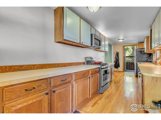 a kitchen with stainless steel appliances granite countertop a sink and cabinets