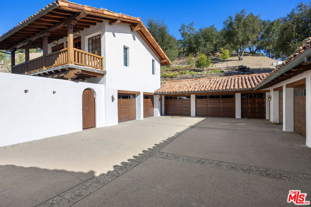 25127 Jim Bridger Road Hidden Hills, CA 91302 - Photo 47 of 50 a front view of a house with a yard