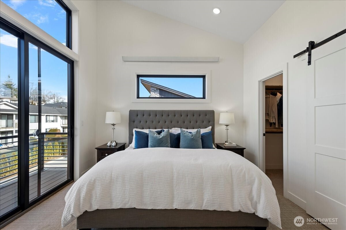 208 Skipping Stone Loop Lynden, WA 98264 - Photo 13 of 28 a bedroom with a large bed and a balcony