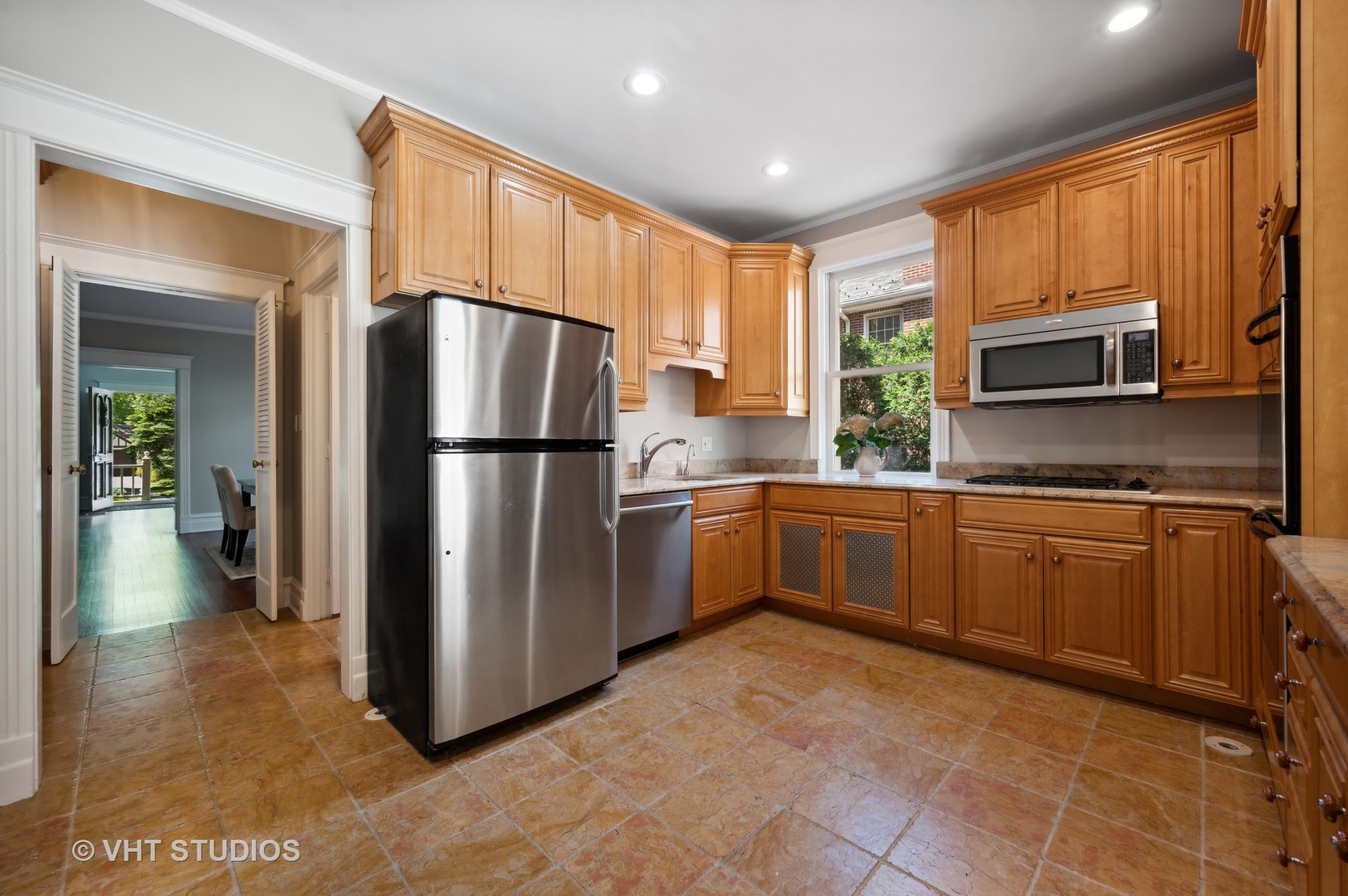 615 Elm Street Winnetka, IL 60093 - Photo 16 of 43 a kitchen with granite countertop a refrigerator stove top oven a sink and dishwasher