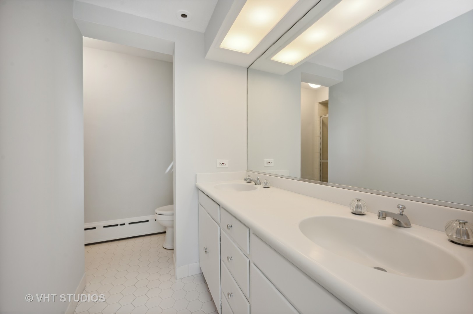 615 Elm Street Winnetka, IL 60093 - Photo 28 of 43 a bathroom with a double vanity sink mirror and toilet