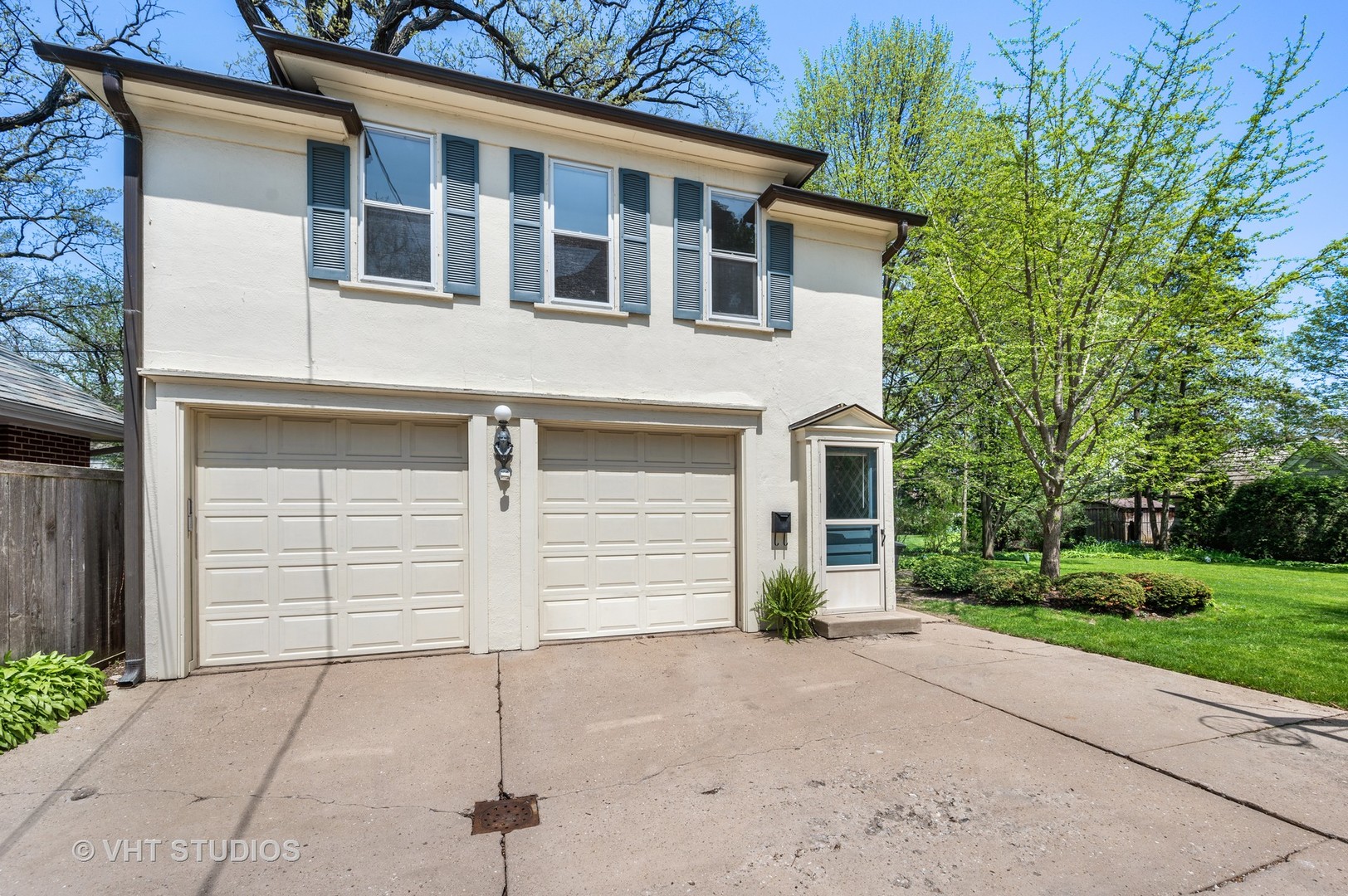 615 Elm Street Winnetka, IL 60093 - Photo 3 of 43 a front view of a house with a yard and garage