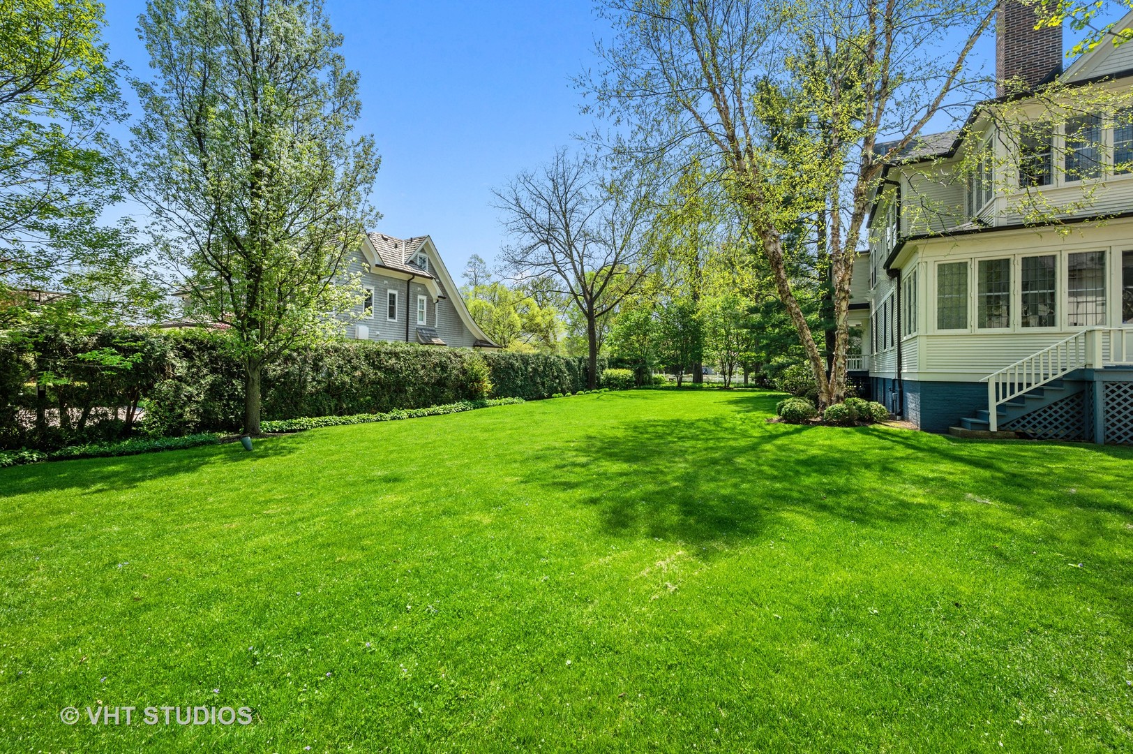 615 Elm Street Winnetka, IL 60093 - Photo 6 of 43 a view of a house next to a big yard and large trees