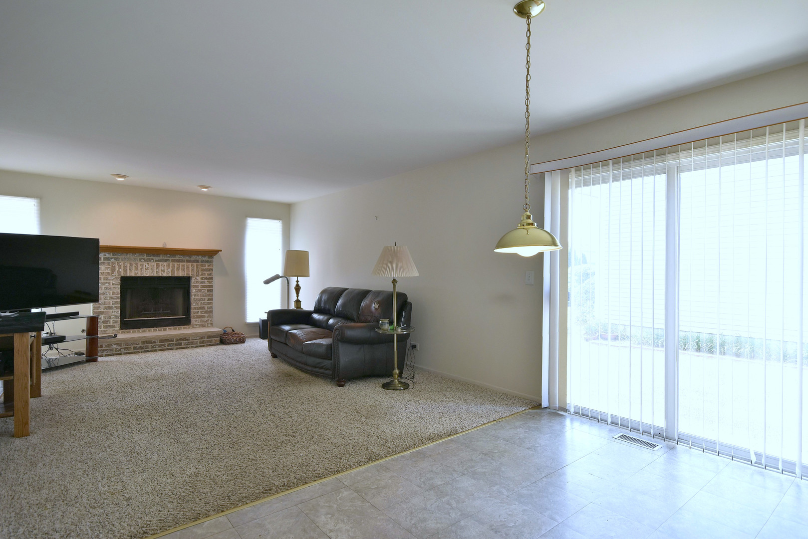 1741 Crofton Drive Algonquin, IL 60102 - Photo 13 of 32 a living room with furniture and a flat screen tv