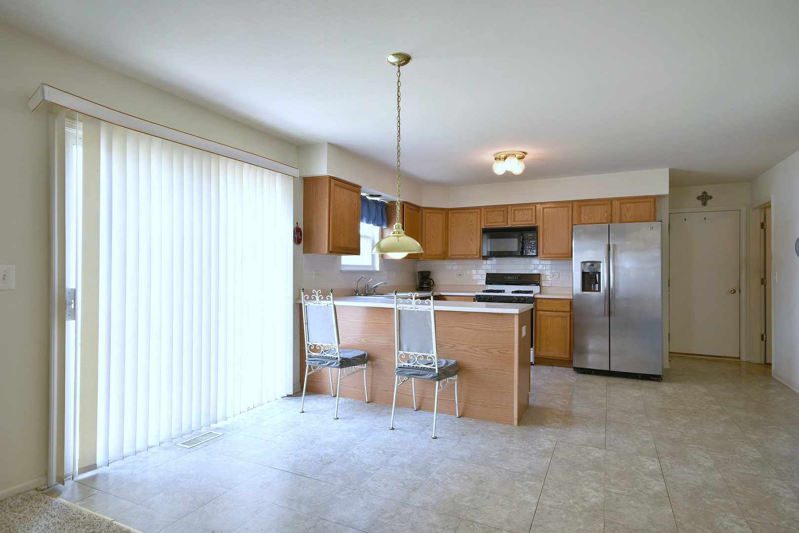1741 Crofton Drive Algonquin, IL 60102 - Photo 14 of 32 a kitchen with refrigerator and chairs