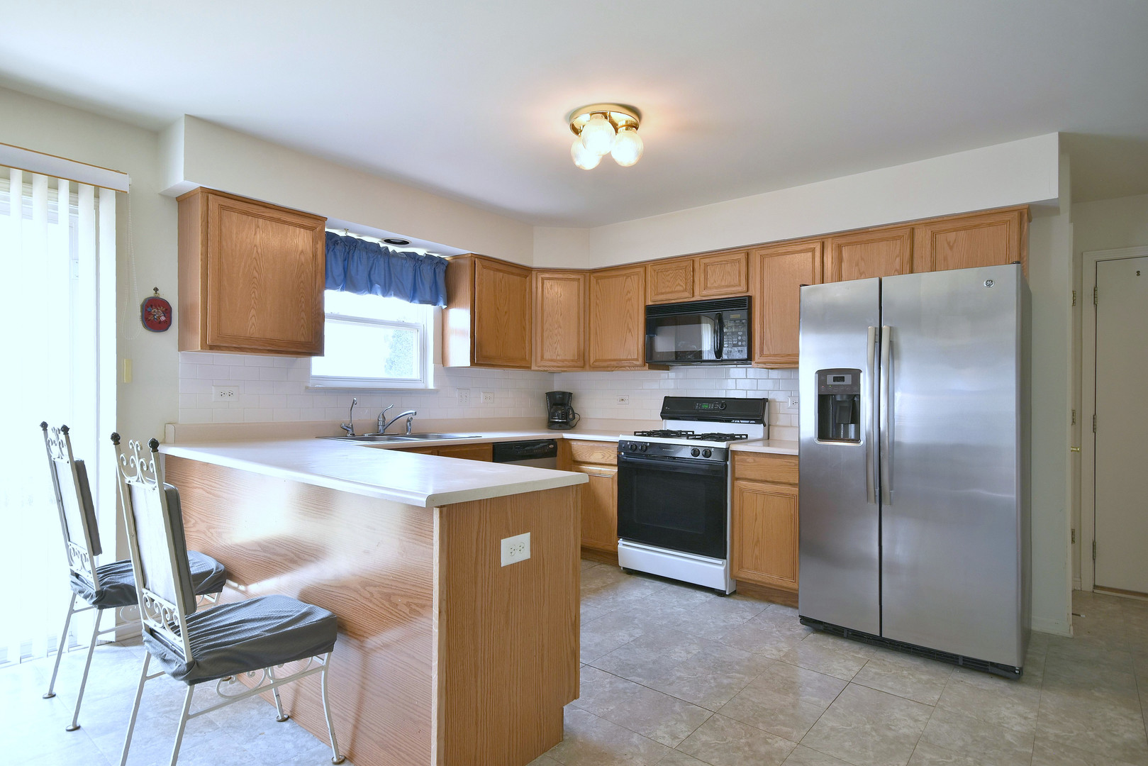 1741 Crofton Drive Algonquin, IL 60102 - Photo 16 of 32 a kitchen with kitchen island a counter top space cabinets and stainless steel appliances