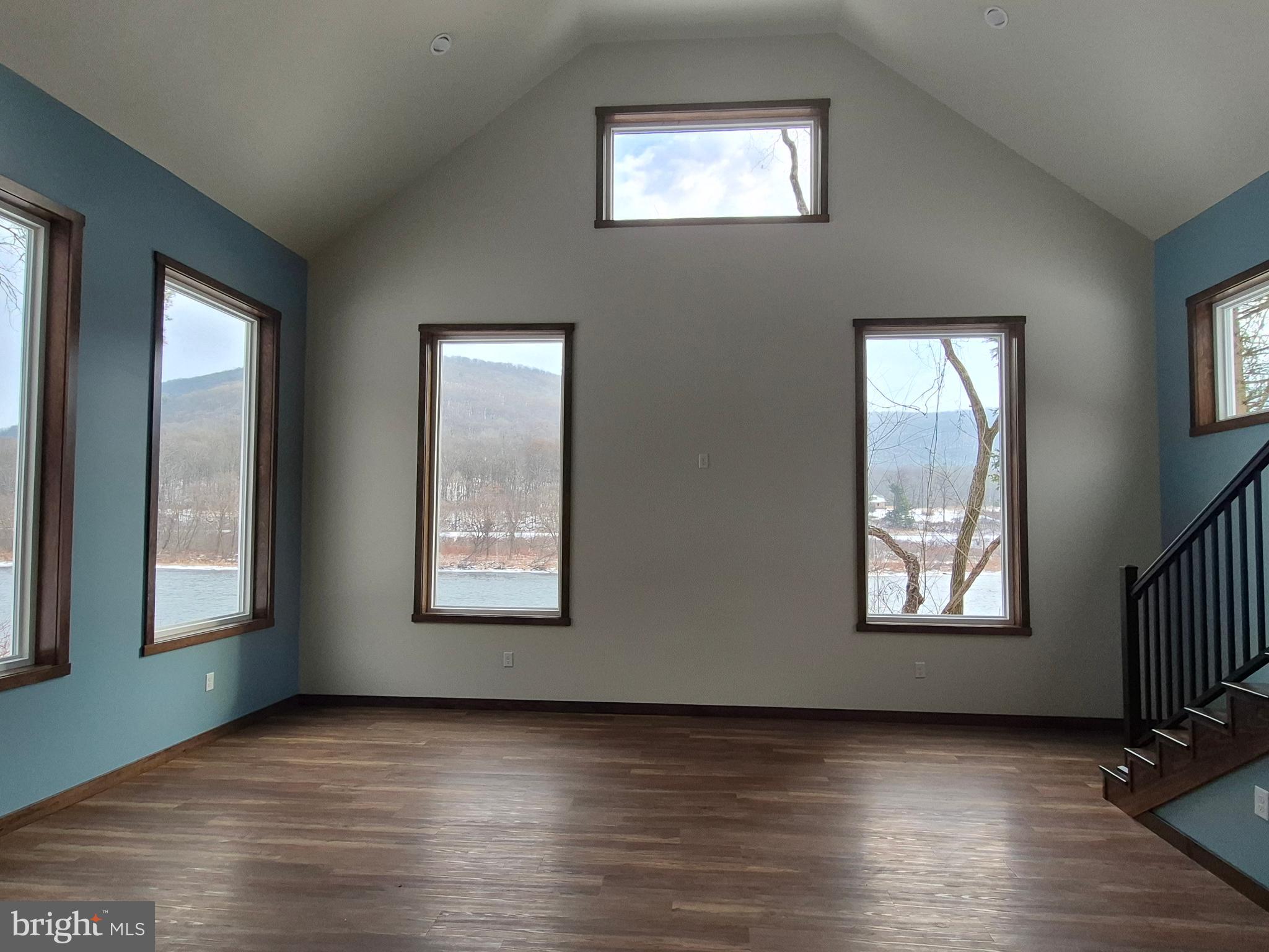 7144 Renovo Road Mill Hall, PA 17751 - Photo 13 of 27 a view of an empty room and wooden floor and windows