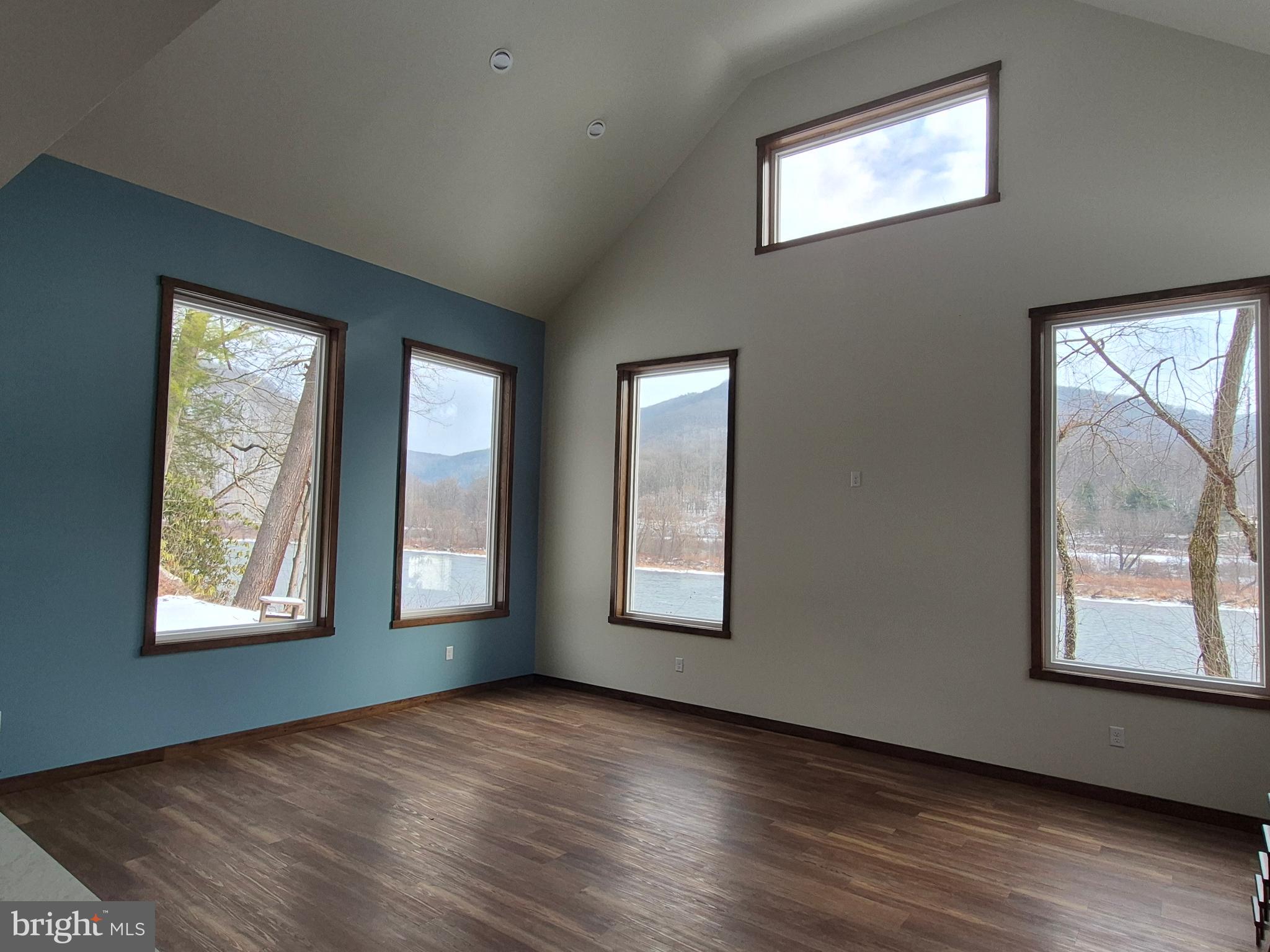7144 Renovo Road Mill Hall, PA 17751 - Photo 14 of 27 a view of an empty room with windows and wooden floor
