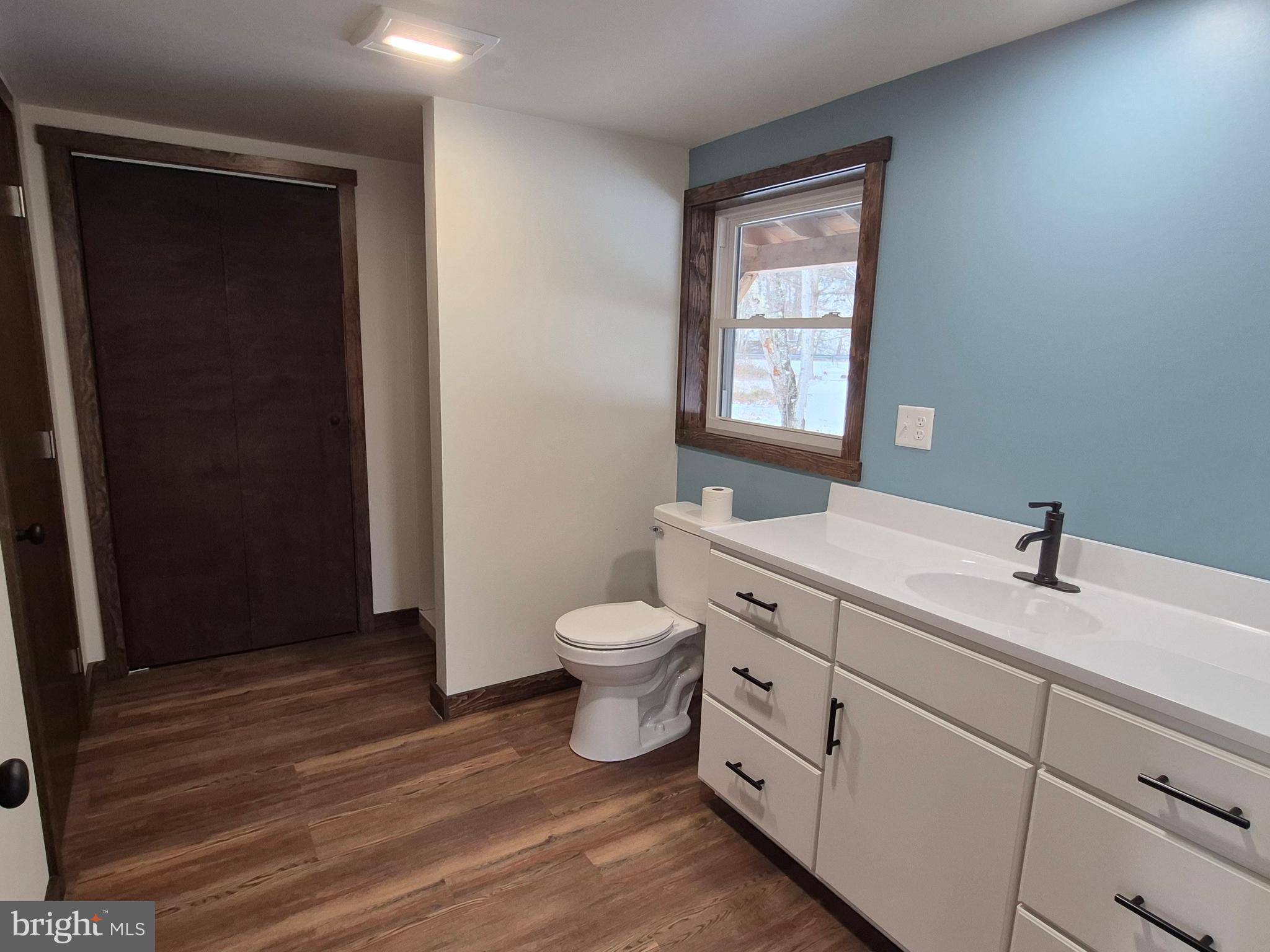 7144 Renovo Road Mill Hall, PA 17751 - Photo 17 of 27 a bathroom with a toilet a sink a vanity and mirror