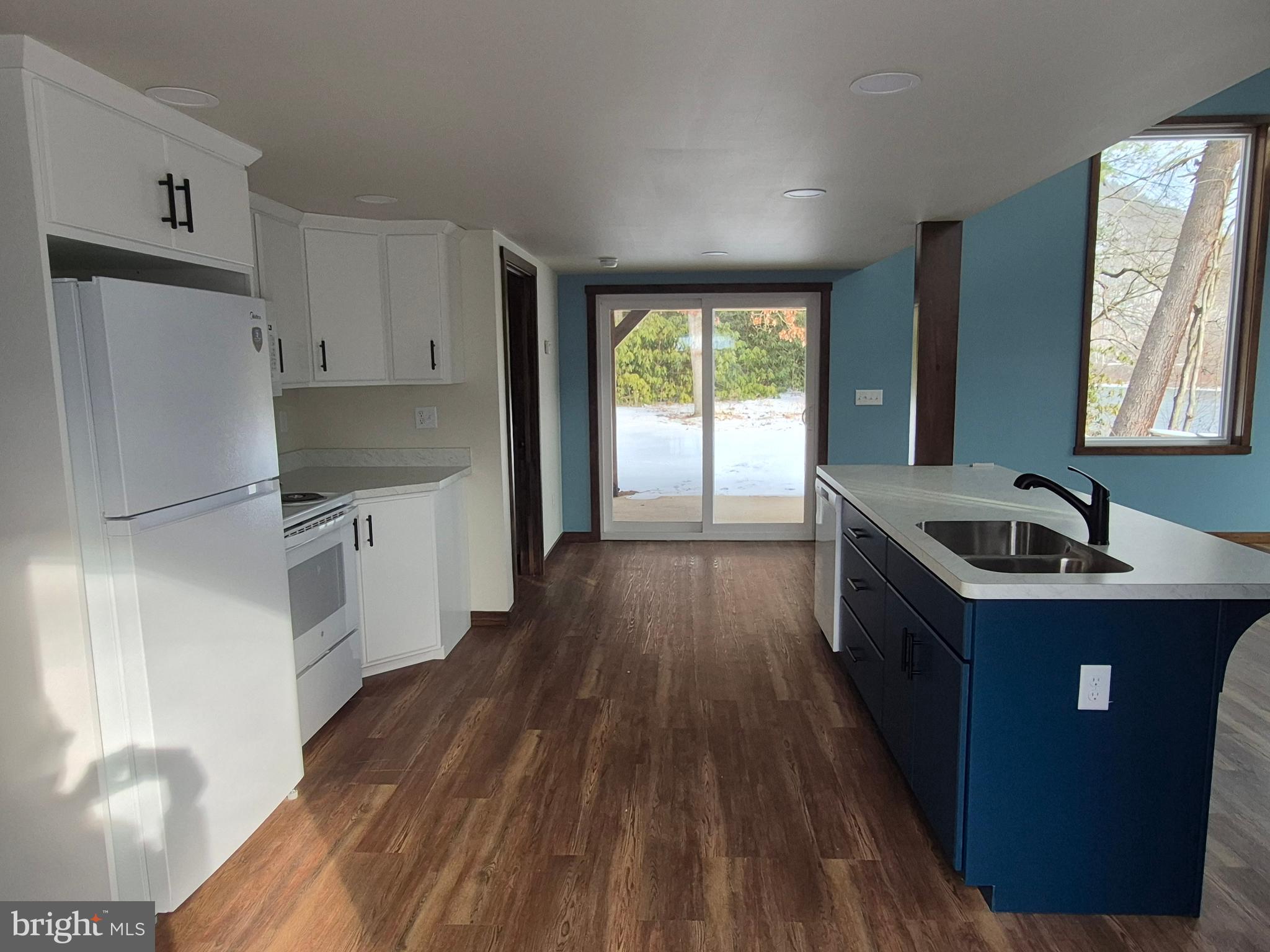 7144 Renovo Road Mill Hall, PA 17751 - Photo 8 of 27 a kitchen with granite countertop a sink wooden floor and stainless steel appliances