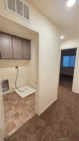 a view of an empty room and a window