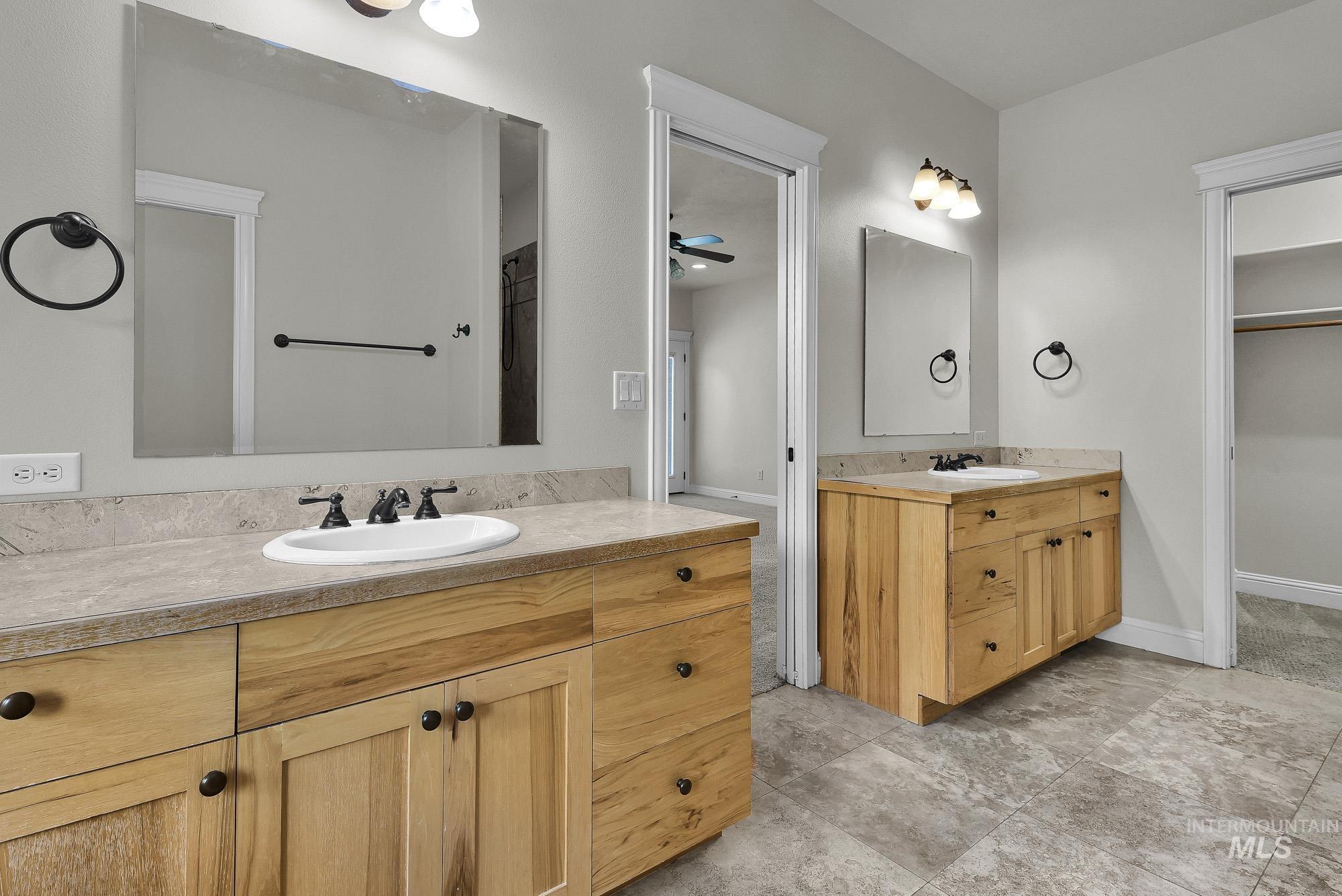 2172 West Cedar Grove Street Meridian, ID 83646 - Photo 18 of 49 Dual vanity bathroom featuring light wood-finish cabinetry