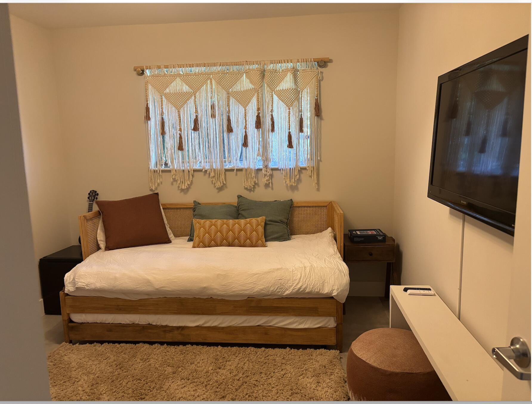 1822 Windsor Drive, Unit 1 Juno Ridge, FL 33408 - Photo 11 of 12 a bedroom with a bed and a couch
