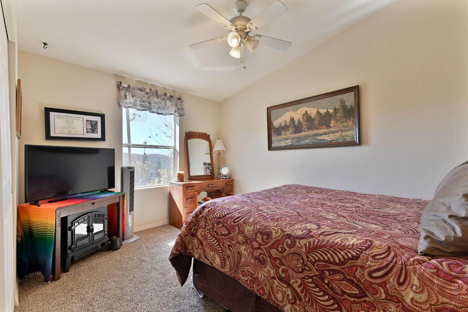 3770 Sheep Ranch Road Murphys, CA 95247 - Photo 32 of 92 a bedroom with a bed and a flat screen tv