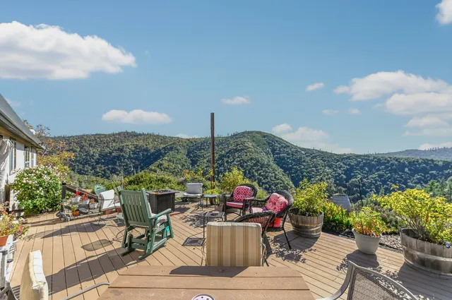 a living room with furniture a fireplace and a large window
