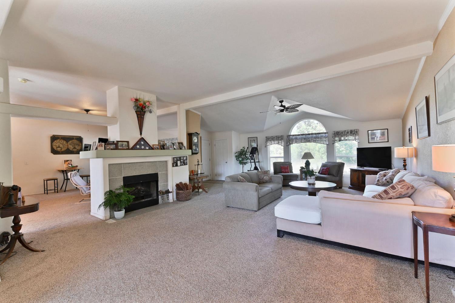 3770 Sheep Ranch Road Murphys, CA 95247 - Photo 8 of 92 a living room with furniture a fireplace and a large window