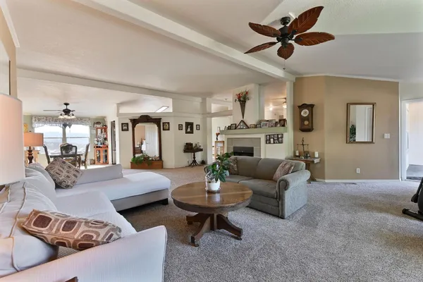 a living room with furniture a window and a flat screen tv