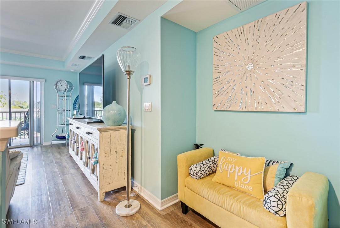 1799 Four Mile Cove Parkway, Unit 925 Cape Coral, FL 33990 - Photo 12 of 49 a living room with furniture and wooden floor