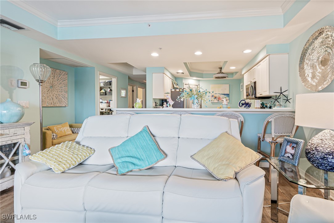 1799 Four Mile Cove Parkway, Unit 925 Cape Coral, FL 33990 - Photo 15 of 49 a living room with a couch and a view of kitchen