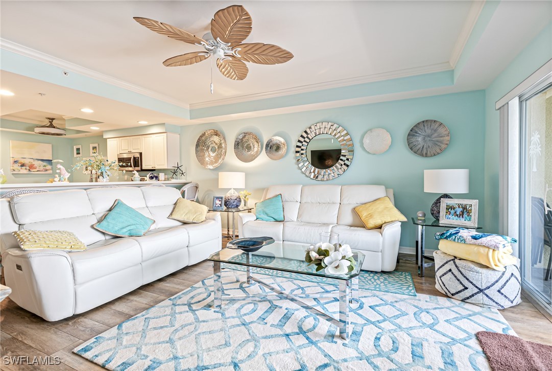 1799 Four Mile Cove Parkway, Unit 925 Cape Coral, FL 33990 - Photo 19 of 49 a living room with furniture and wall clock