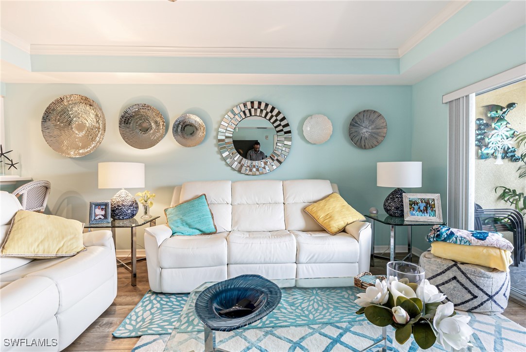 1799 Four Mile Cove Parkway, Unit 925 Cape Coral, FL 33990 - Photo 22 of 49 a living room with furniture and wall painting