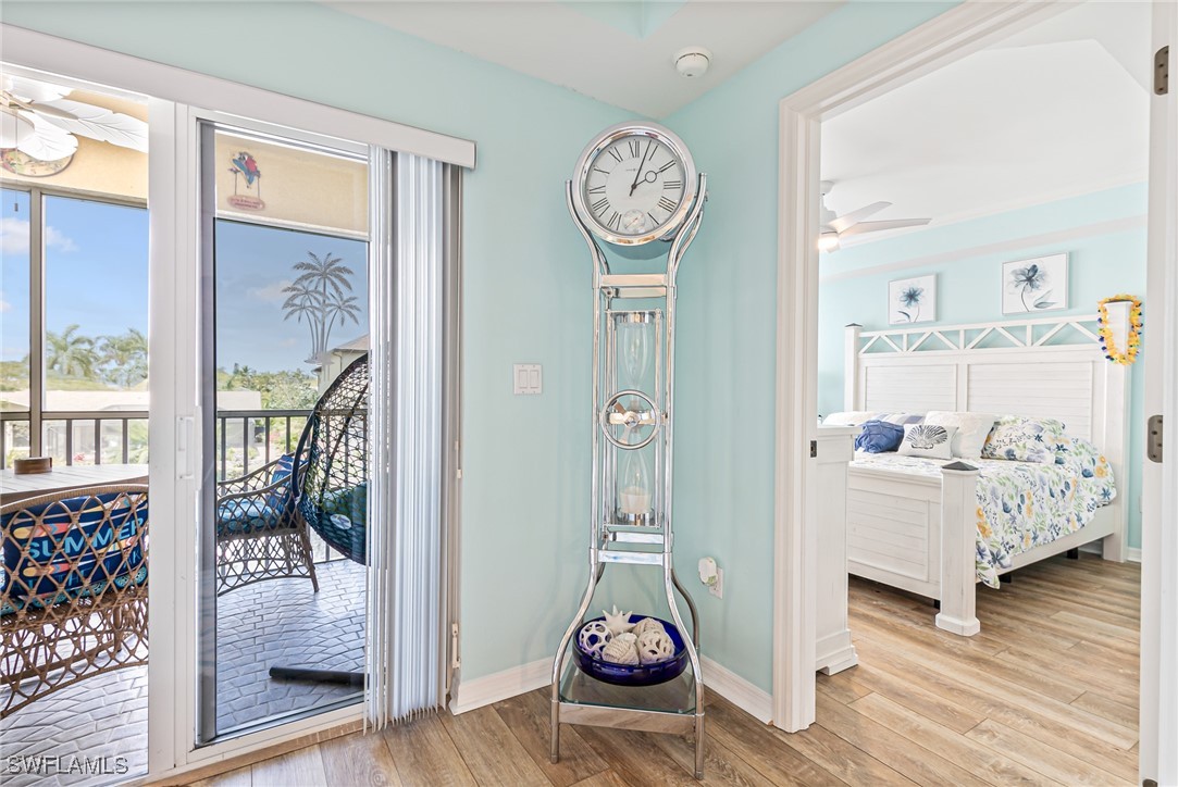1799 Four Mile Cove Parkway, Unit 925 Cape Coral, FL 33990 - Photo 25 of 49 a view of a bedroom with a bed and glass door