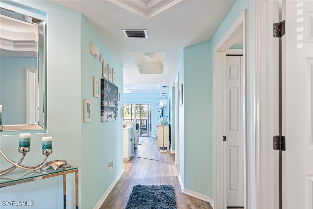 1799 Four Mile Cove Parkway, Unit 925 Cape Coral, FL 33990 - Photo 3 of 49 a view of a hallway with wooden floor and a bathroom