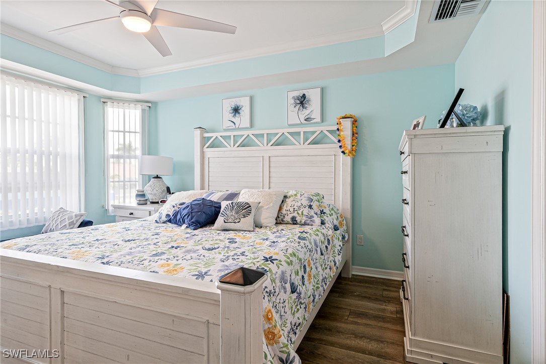 1799 Four Mile Cove Parkway, Unit 925 Cape Coral, FL 33990 - Photo 31 of 49 a bedroom with a bed and a chandelier