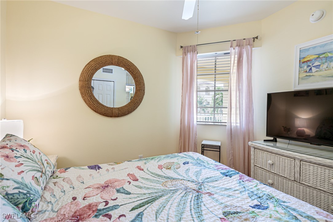 1799 Four Mile Cove Parkway, Unit 925 Cape Coral, FL 33990 - Photo 32 of 49 a bedroom with a bed and a flat screen tv