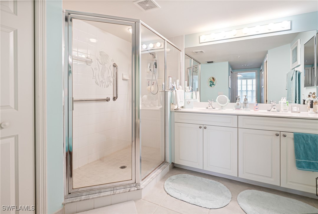1799 Four Mile Cove Parkway, Unit 925 Cape Coral, FL 33990 - Photo 39 of 49 a spacious bathroom with a shower a sink and a mirror