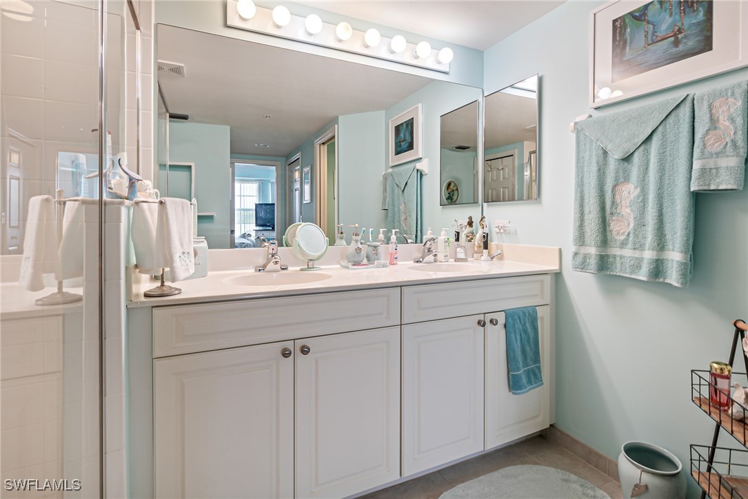 1799 Four Mile Cove Parkway, Unit 925 Cape Coral, FL 33990 - Photo 40 of 49 a bathroom with a sink double vanity and a mirror