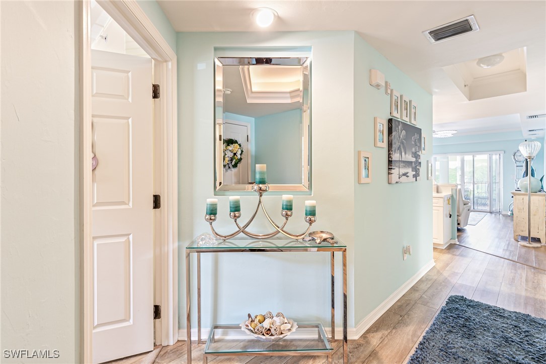 1799 Four Mile Cove Parkway, Unit 925 Cape Coral, FL 33990 - Photo 4 of 49 a view of a hallway with wooden floor and living room