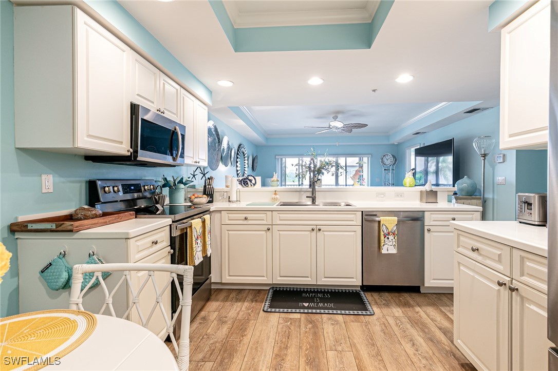 1799 Four Mile Cove Parkway, Unit 925 Cape Coral, FL 33990 - Photo 7 of 49 a kitchen with a sink a stove and cabinets