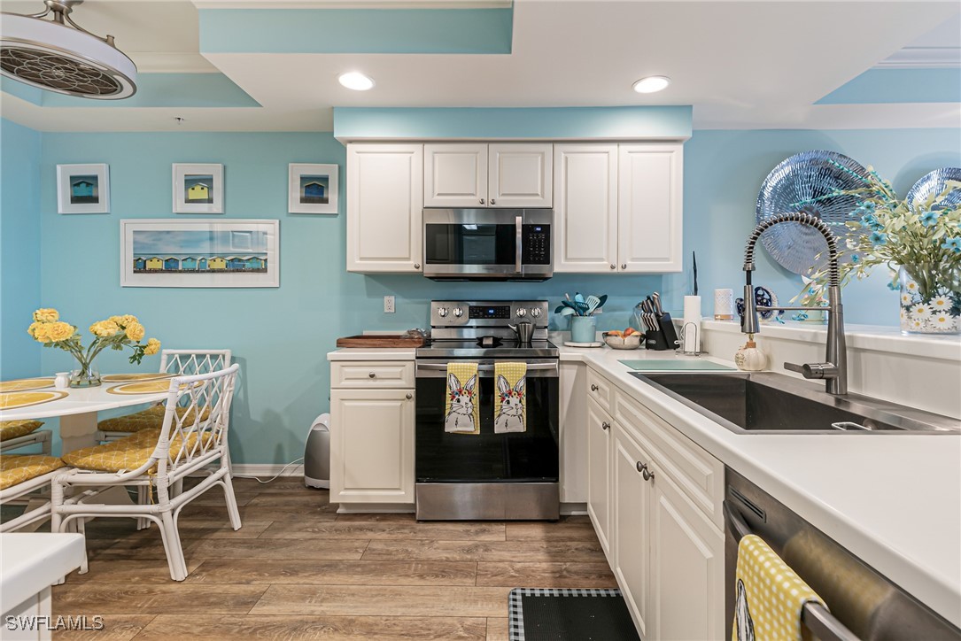 1799 Four Mile Cove Parkway, Unit 925 Cape Coral, FL 33990 - Photo 9 of 49 a kitchen with a sink cabinets and window