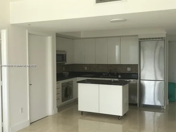 a close view of stove top oven and refrigerator