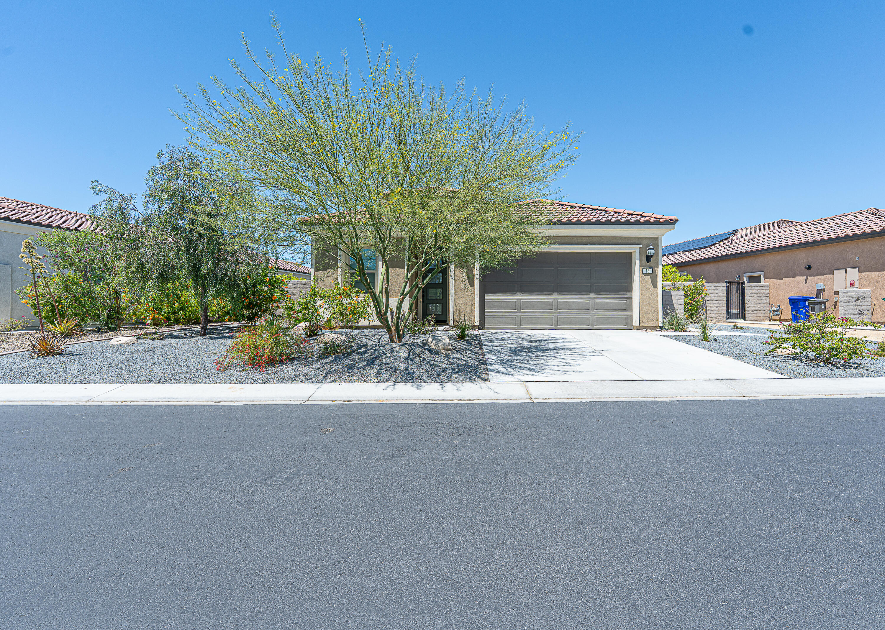 18 Vintage Rancho Mirage, CA 92270 - Photo 6 of 54 a front view of a house with a yard and garage