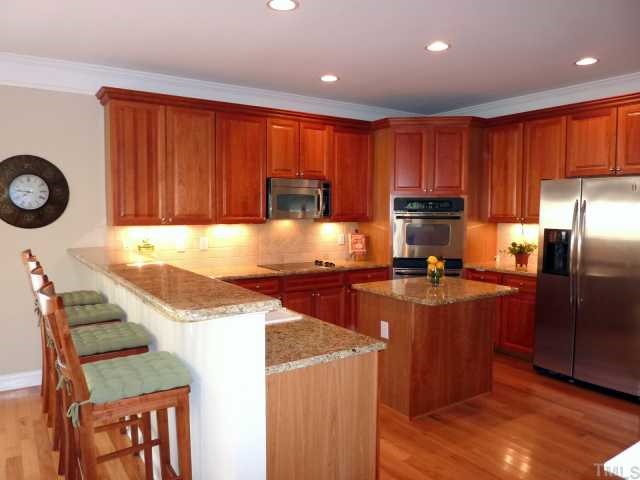 3201 Canes Way Raleigh, NC 27614 - Photo 2 of 11 a kitchen with granite countertop stainless steel appliances a stove top oven a sink and dishwasher