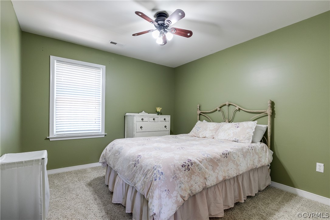 9518 Dunroming Road Chesterfield, VA 23832 - Photo 20 of 47 a bedroom with a bed and a chandelier